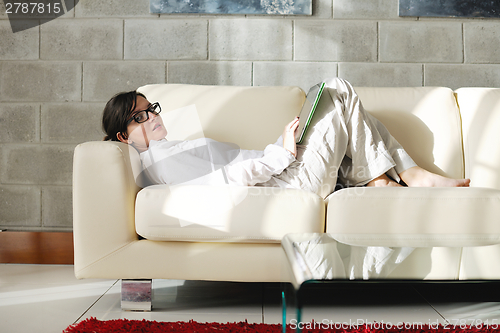 Image of woman using tablet pc at home