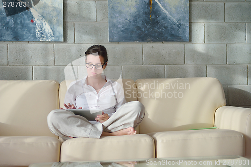 Image of woman using tablet pc at home