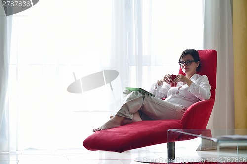 Image of woman using tablet pc at home