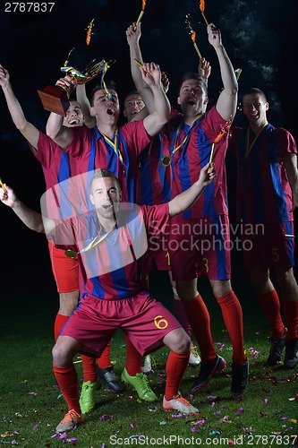 Image of soccer players celebrating victory