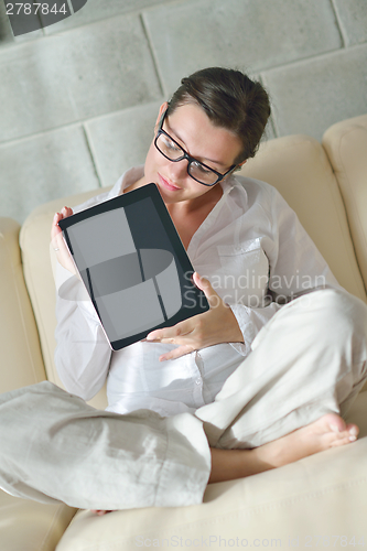 Image of woman using tablet pc at home