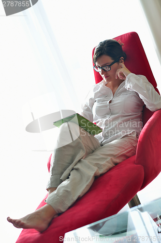 Image of woman using tablet pc at home