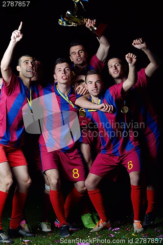 Image of soccer players celebrating victory