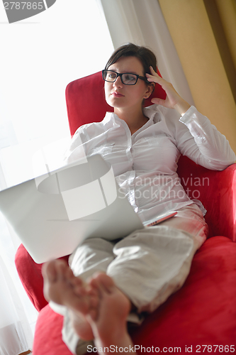 Image of woman using a laptop computer at home