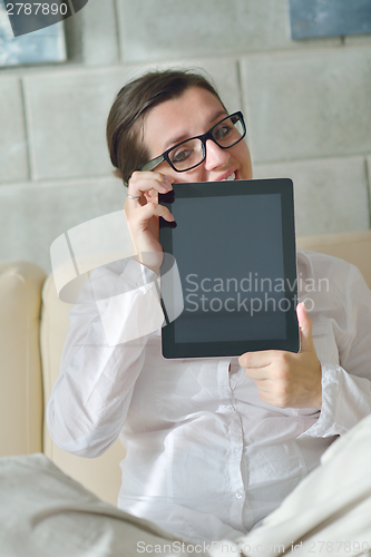Image of woman using tablet pc at home
