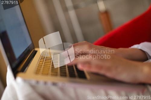 Image of woman using a laptop computer at home
