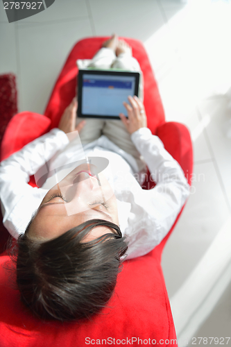 Image of woman using tablet pc at home