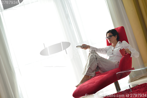 Image of happy young woman relax at home on sofa