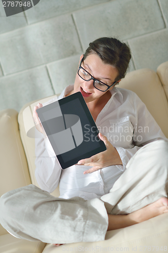 Image of woman using tablet pc at home