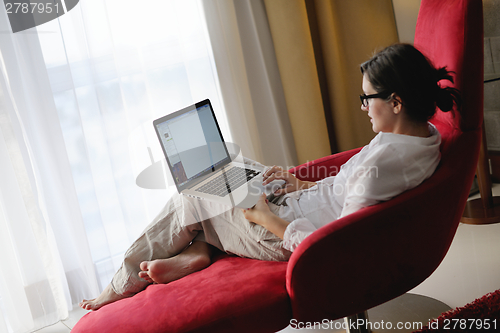 Image of woman using a laptop computer at home