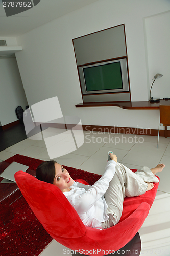 Image of happy young woman relax at home on sofa