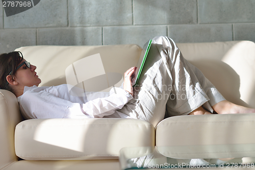 Image of woman using tablet pc at home