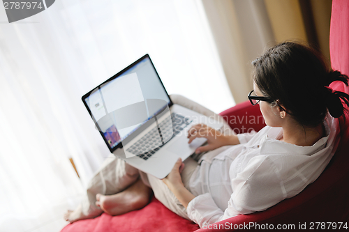 Image of woman using a laptop computer at home