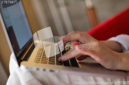 Image of woman using a laptop computer at home