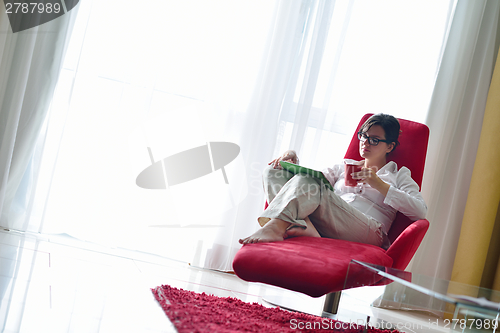 Image of woman using tablet pc at home