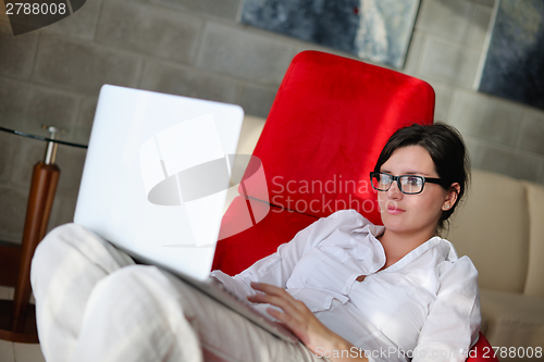 Image of woman using a laptop computer at home
