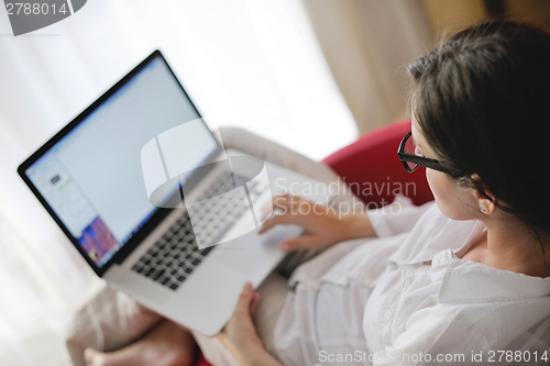 Image of woman using a laptop computer at home