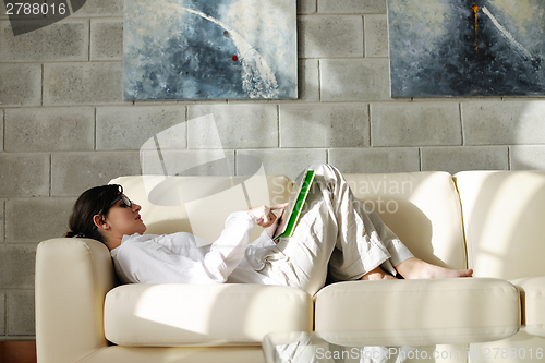 Image of woman using tablet pc at home