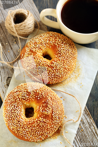 Image of Bagels with sesame seeds and black coffee. 