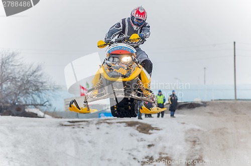 Image of Jump of sportsman on snowmobile