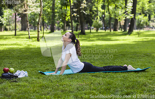 Image of Girl Stretching in a Green Park