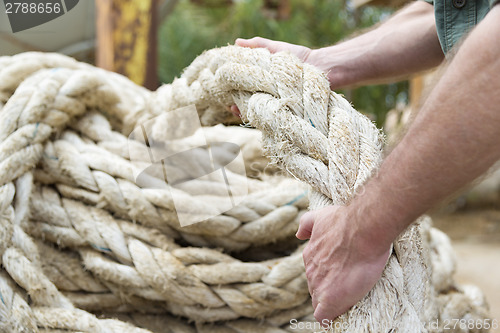 Image of Hands pulling rope