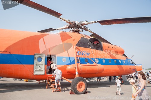 Image of Visitors of air show explore the MI-6A helicopter