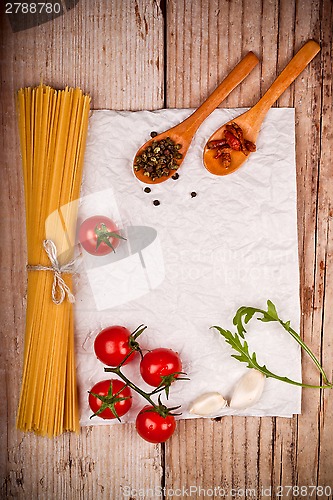 Image of uncooked pasta with tomatoes and spices 