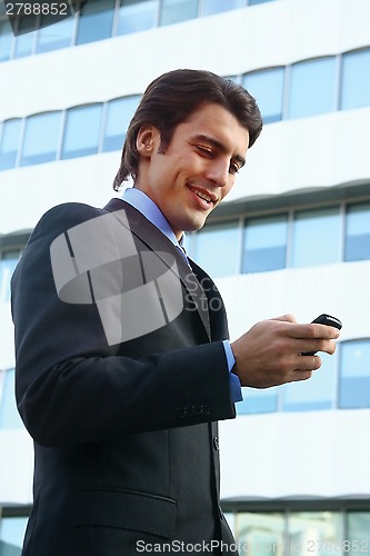 Image of a businessman using mobile phone b
