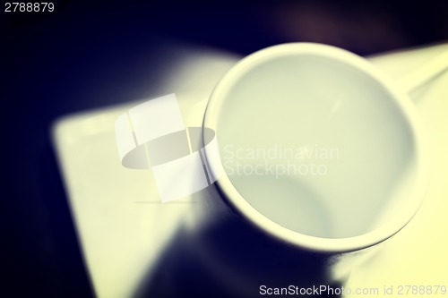 Image of White cup on dark table