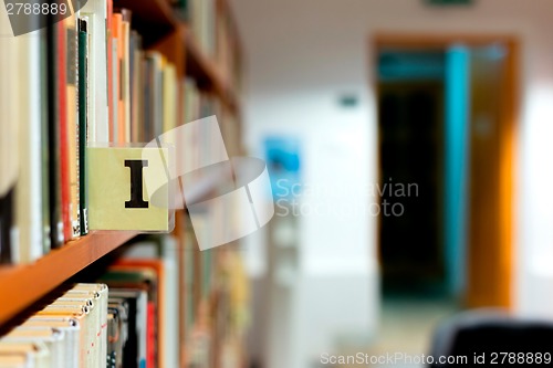 Image of Library bookshelf closeup with letter