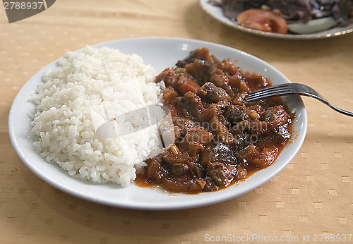 Image of Meat with rice on a plate