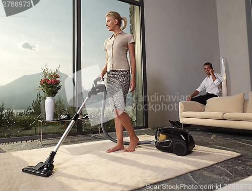 Image of housewife with vacuum cleaner