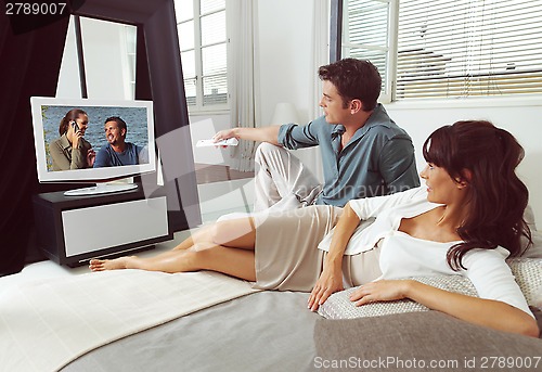 Image of Couple on sofa with TV remote