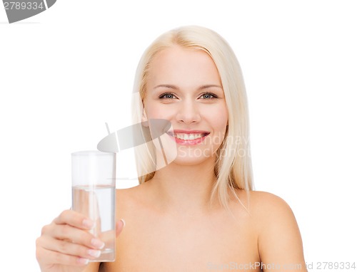 Image of young smiling woman with glass of water