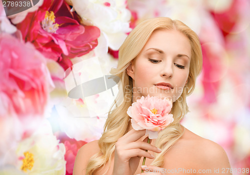 Image of lovely woman with peony flower
