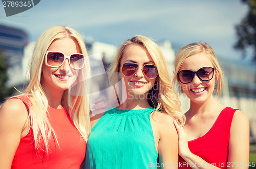 Image of three beautiful women in the city