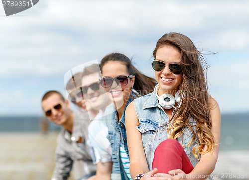 Image of smiling teenage girl hanging out with friends