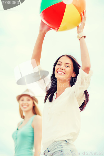 Image of girls playing ball on the beach