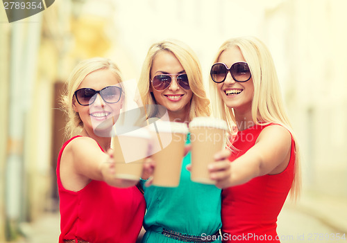 Image of women with takeaway coffee cups in the city