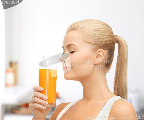 Image of young woman drinking orange juice