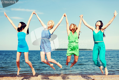 Image of girls jumping on the beach