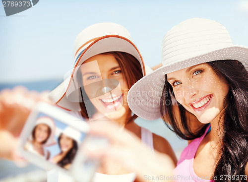 Image of girls taking self portrait on the beach