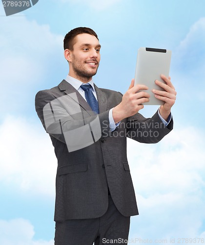 Image of smiling buisnessman with tablet pc computer
