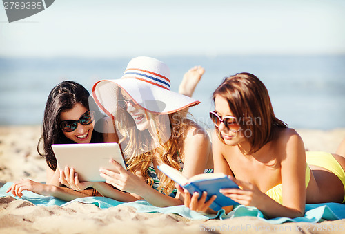 Image of girls with tablet pc on the beach