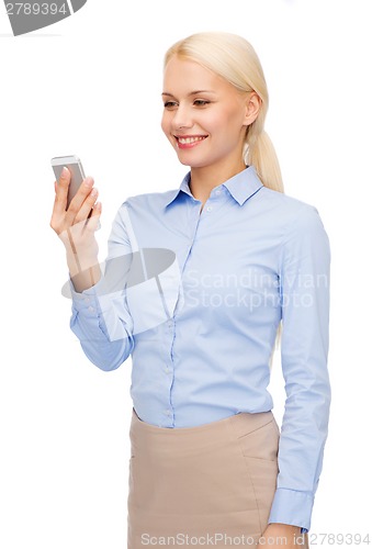 Image of young smiling businesswoman with smartphone