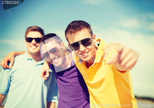 Image of group of friends having fun on the beach