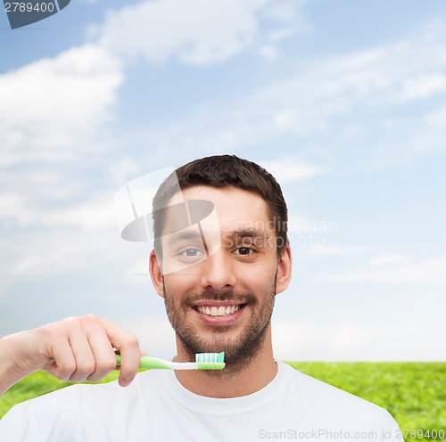 Image of smiling young man with toothbrush