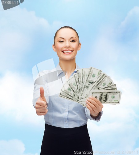 Image of young businesswoman with dollar cash money