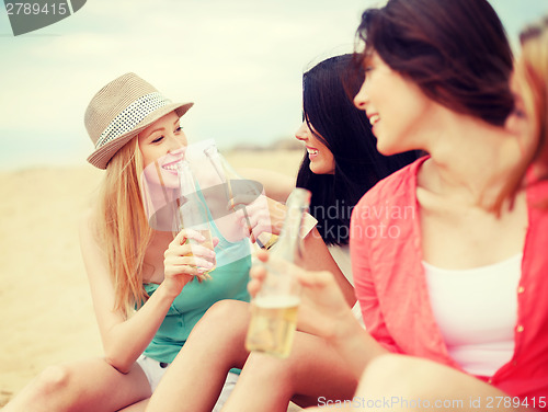 Image of girls with drinks on the beach
